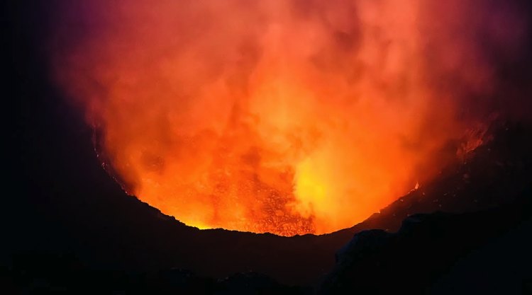 Molten magma glowing orange deep inside the Santiago crater at Masaya Volcano after dark