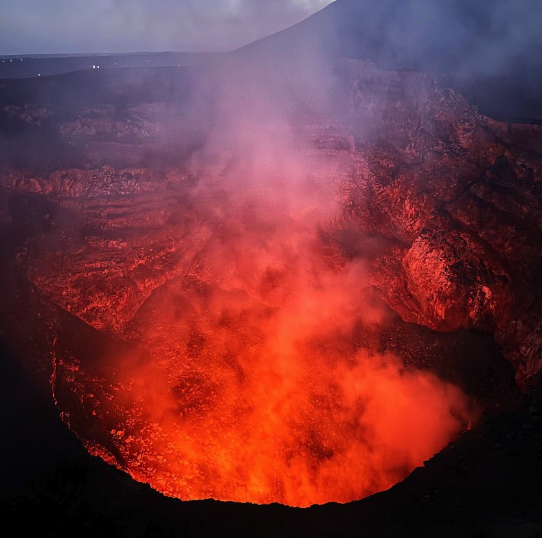 The Santiago crater filled with red-lit gas on a Masaya Volcano night tour