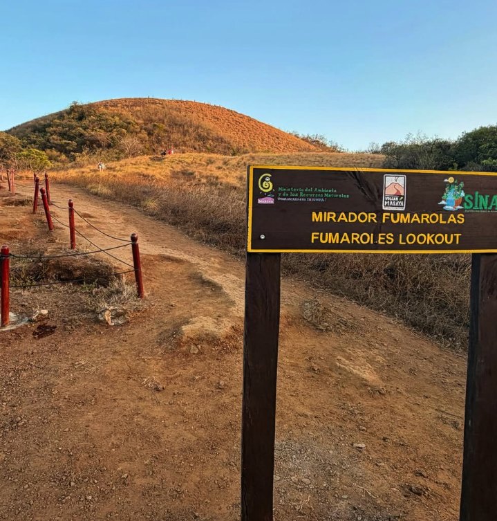 The Mirador Fumarolas signpost at Masaya Volcano with the bare cone of El Comalito behind