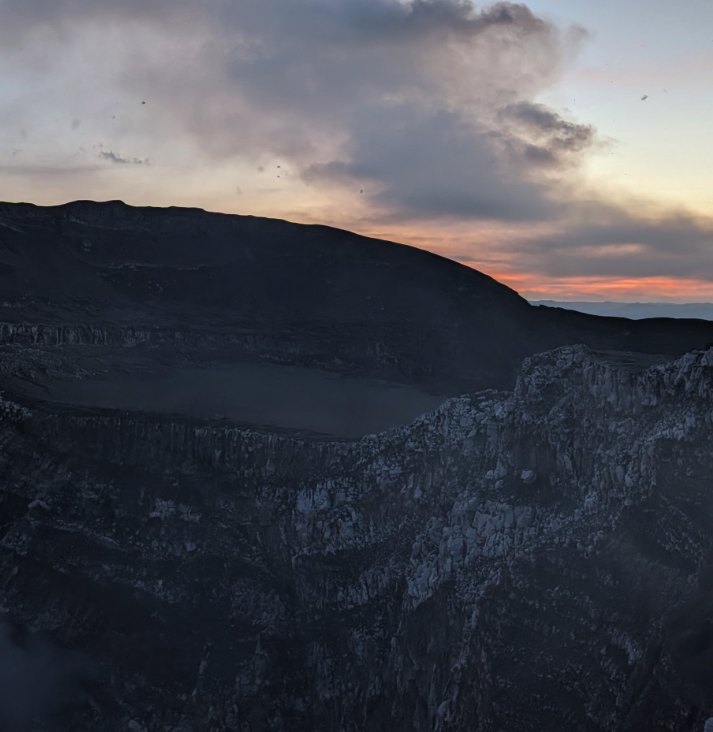 Sunset over the Masaya Volcano crater rim with the first orange glow showing below